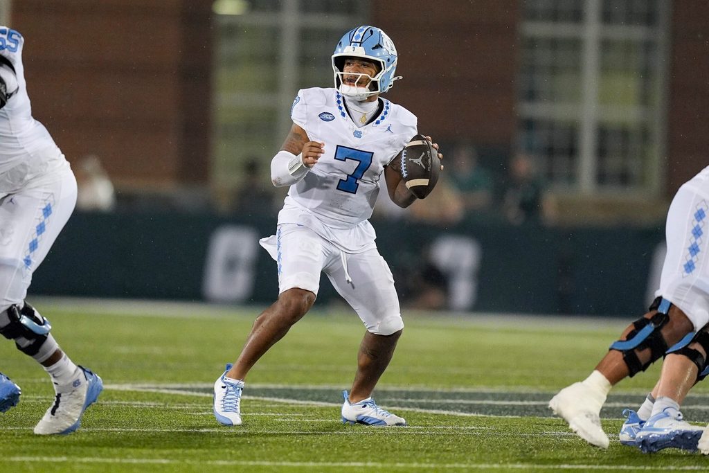 Sep 6, 2025; Charlotte, North Carolina, USA; North Carolina Tar Heels quarterback Gio Lopez (7) looks for a receiver against the Charlotte 49ers during the second half at Jerry Richardson Stadium. Mandatory Credit: Jim Dedmon-Imagn Images