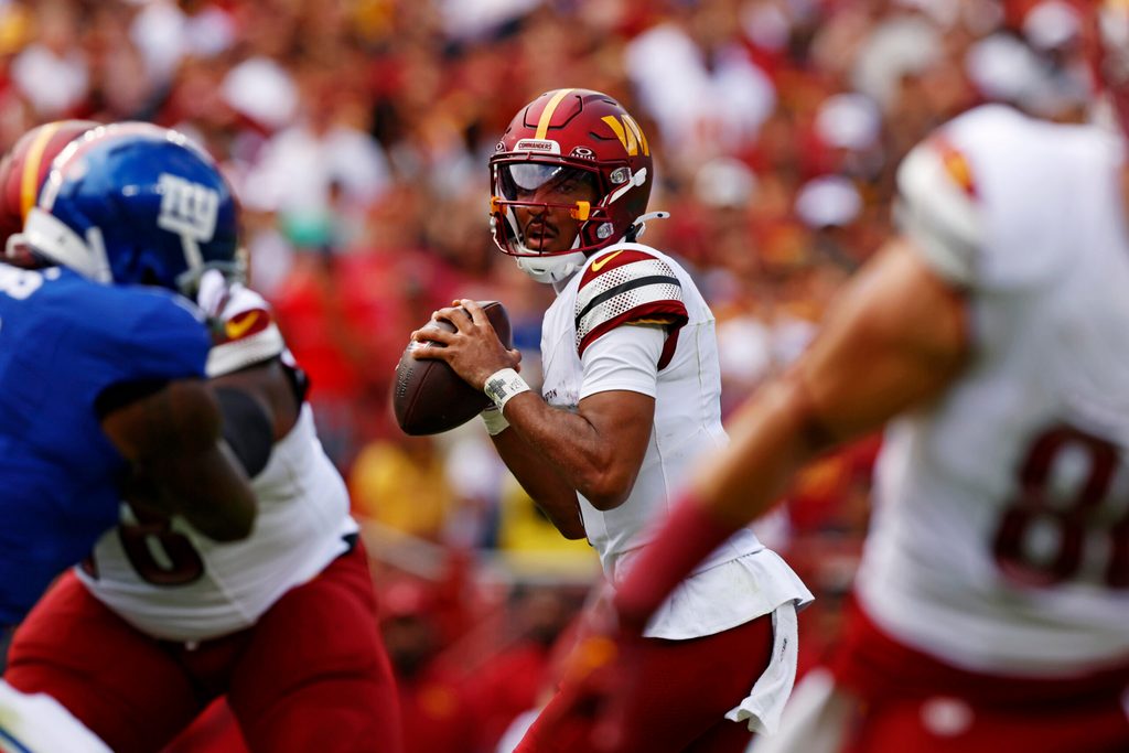 Sep 7, 2025; Landover, Maryland, USA; Washington Commanders quarterback Jayden Daniels (5) drops back to pass during the first quarter against the New York Giants at Northwest Stadium. Mandatory Credit: Peter Casey-Imagn Images