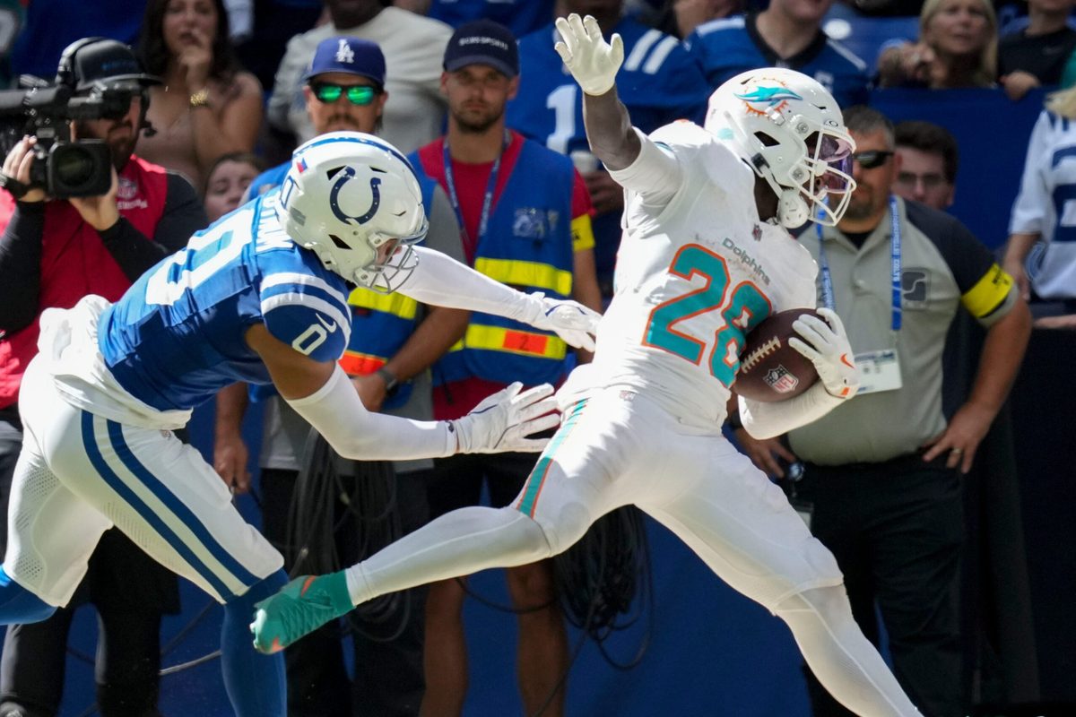Sep 7, 2025; Indianapolis, Indiana, USA; Indianapolis Colts safety Camryn Bynum (0) pushes Miami Dolphins running back De'Von Achane (28) during the second half of a game at Lucas Oil Stadium. Mandatory Credit: Christine Tannous-USA TODAY Network via Imagn Images