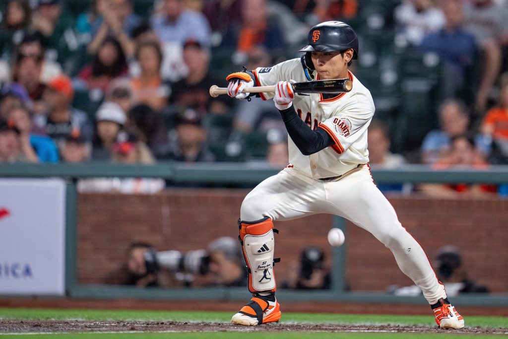 Sep 8, 2025; San Francisco, California, USA; San Francisco Giants center fielder Jung Hoo Lee (51) bunt hits to load the bases against the Arizona Diamondbacks during the sixth inning at Oracle Park. Mandatory Credit: Neville E. Guard-Imagn Images