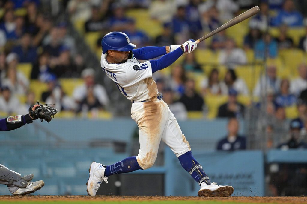 Sep 10, 2025; Los Angeles, California, USA; Los Angeles Dodgers shortstop Mookie Betts (50) hits a grand slam home run during the eighth inning against the Colorado Rockies at Dodger Stadium. Mandatory Credit: Jayne Kamin-Oncea-Imagn Images