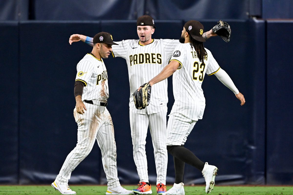 Sep 11, 2025; San Diego, California, USA; San Diego Padres right fielder Ramon Laureano (5), left, Jackson Merrill (3), center, and Fernando Tatis Jr. (23) celebrate after the Padres defeated the Colorado Rockies at Petco Park. Mandatory Credit: Denis Poroy-Imagn Images