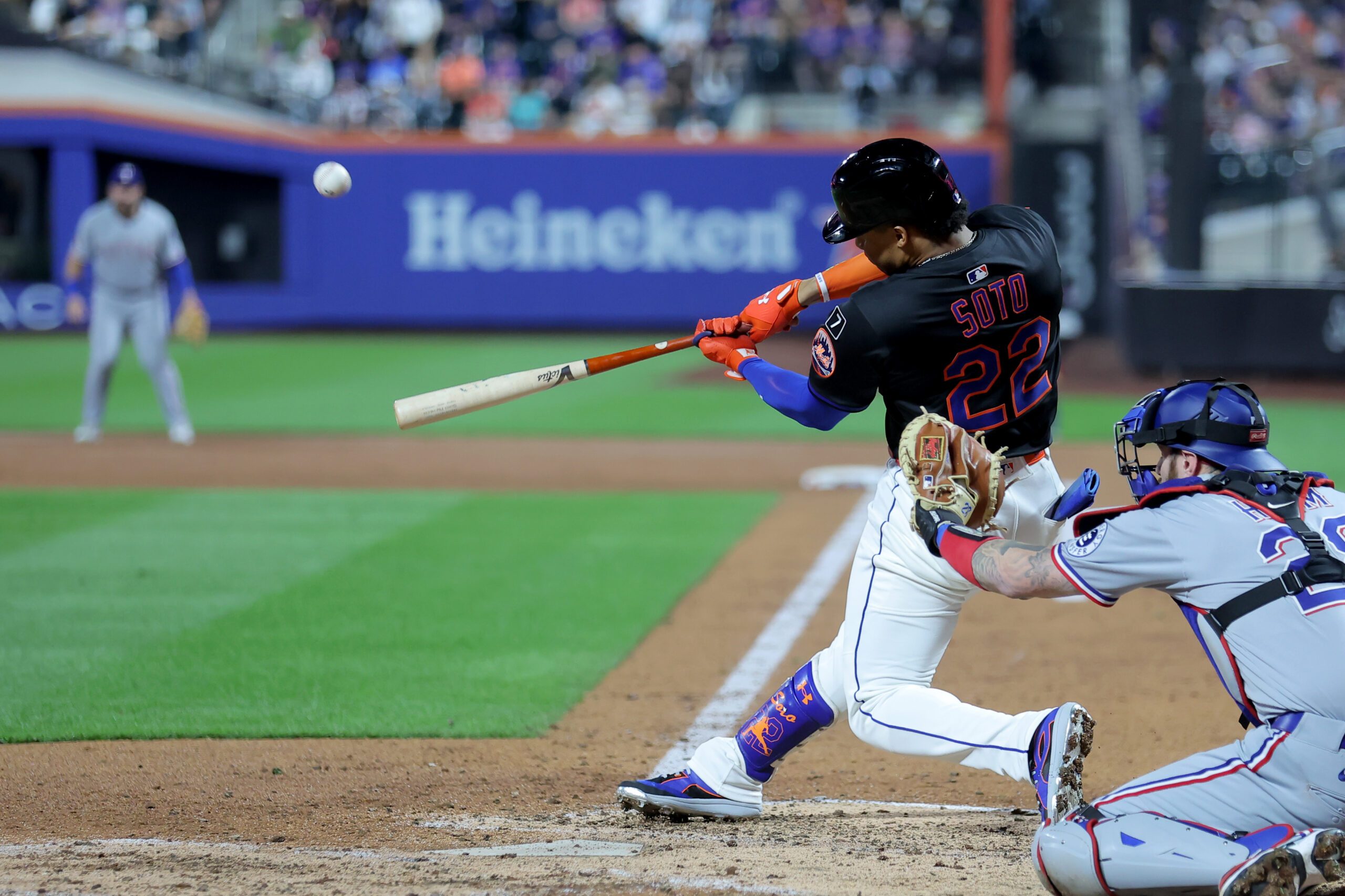 Sep 12, 2025; New York City, New York, USA; New York Mets right fielder Juan Soto (22) hits an RBI sacrifice fly during the third inning against the Texas Rangers at Citi Field. Mandatory Credit: Brad Penner-Imagn Images