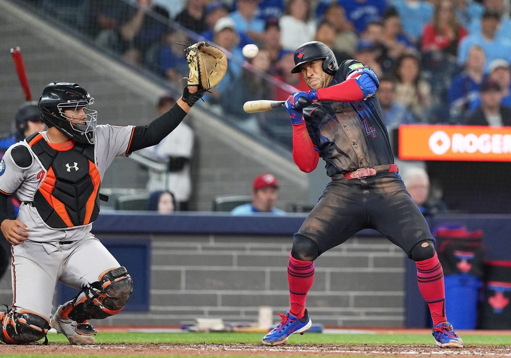 Sep 12, 2025; Toronto, Ontario, CAN; Toronto Blue Jays right fielder George Springer (4) manages to get out of the way of a high pitch against the Baltimore Orioles during the eighth inning at Rogers Centre. Mandatory Credit: Nick Turchiaro-Imagn Images