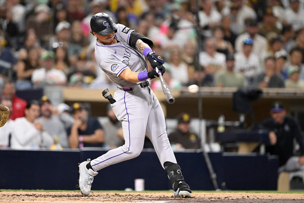 Sep 12, 2025; San Diego, California, USA; Colorado Rockies left fielder Jordan Beck (27) hits a single during the fourth inning against the San Diego Padres at Petco Park. Mandatory Credit: Denis Poroy-Imagn Images