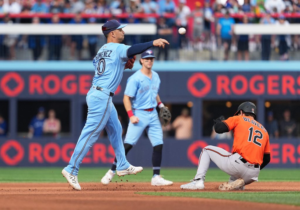 Sep 13, 2025; Toronto, Ontario, CAN; Baltimore Orioles right fielder Dylan Beavers (12) is tagged out at second base by Toronto Blue Jays shortstop Andres Gimenez (0) during the eighth inning at Rogers Centre. Mandatory Credit: Nick Turchiaro-Imagn Images