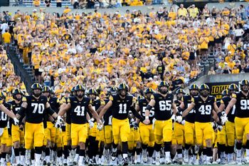 The Iowa Hawkeyes swarm onto the field before the football game against the Massachusetts Minutemen Sept. 13, 2025 at Kinnick Stadium in Iowa City, Iowa.