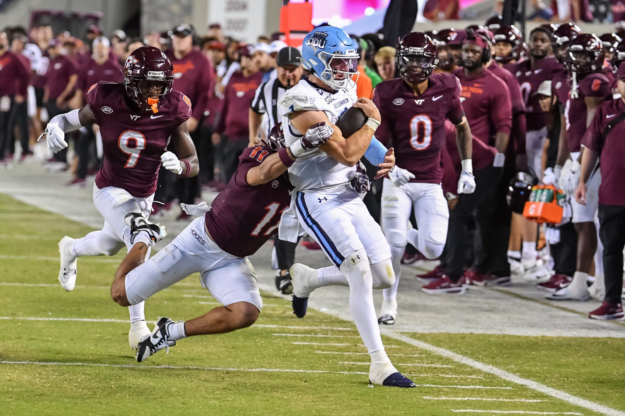Sep 13, 2025; Blacksburg, Virginia, USA;  Virginia Tech Hokies safety Tyson Flowers (11) tackles Old Dominion Monarchs quarterback Colton Joseph (1) during the third quarter at Lane Stadium. Mandatory Credit: Brian Bishop-Imagn Images