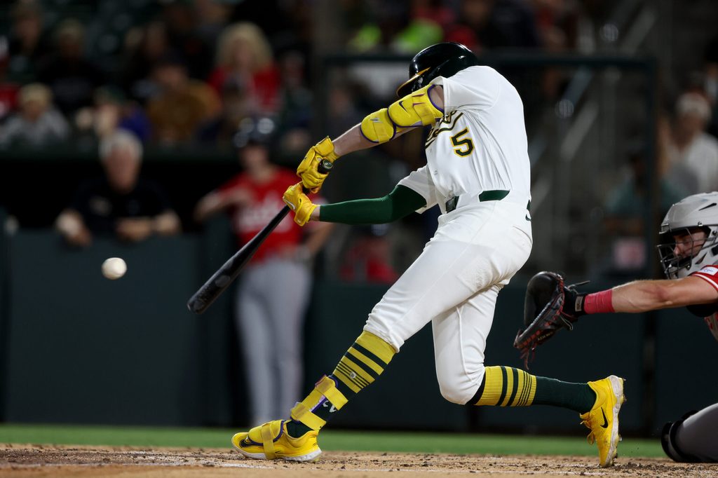 Sep 13, 2025; West Sacramento, California, USA; Athletics shortstop Jacob Wilson (5) hits a RBI ground rule double against the Cincinnati Reds during the third inning at Sutter Health Park. Mandatory Credit: Dennis Lee-Imagn Images