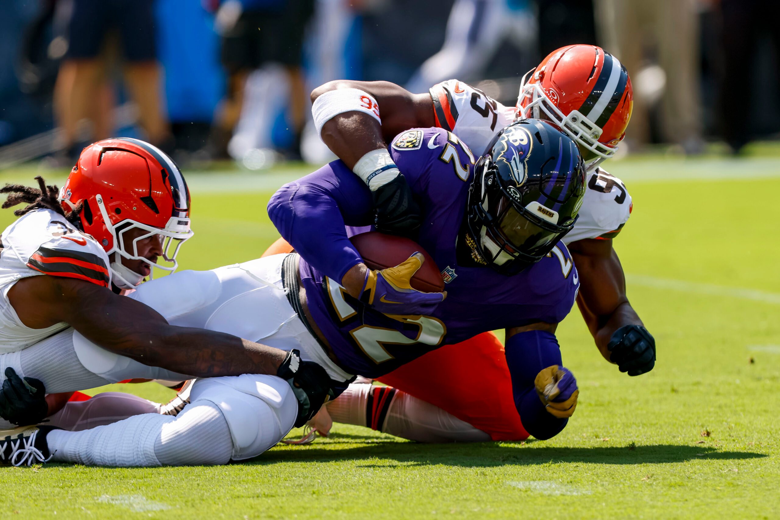 Sep 14, 2025; Baltimore, Maryland, USA; Baltimore Ravens running back Derrick Henry (22) is tackled by Cleveland Browns defensive end Myles Garrett (95) during the first quarter at M&T Bank Stadium. Mandatory Credit: Peter Casey-Imagn Images