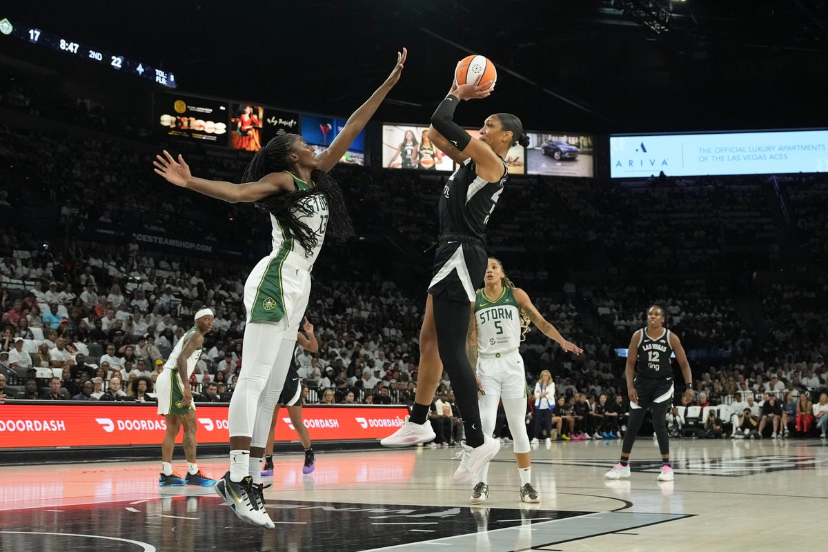 Sep 14, 2025; Las Vegas, Nevada, USA; Las Vegas Aces center A'ja Wilson (22) shoots against Seattle Storm forward Ezi Magbegor (13) in the second quarter during game one of round one for the 2025 WNBA Playoffs at Michelob Ultra Arena. Mandatory Credit: Candice Ward-Imagn Images