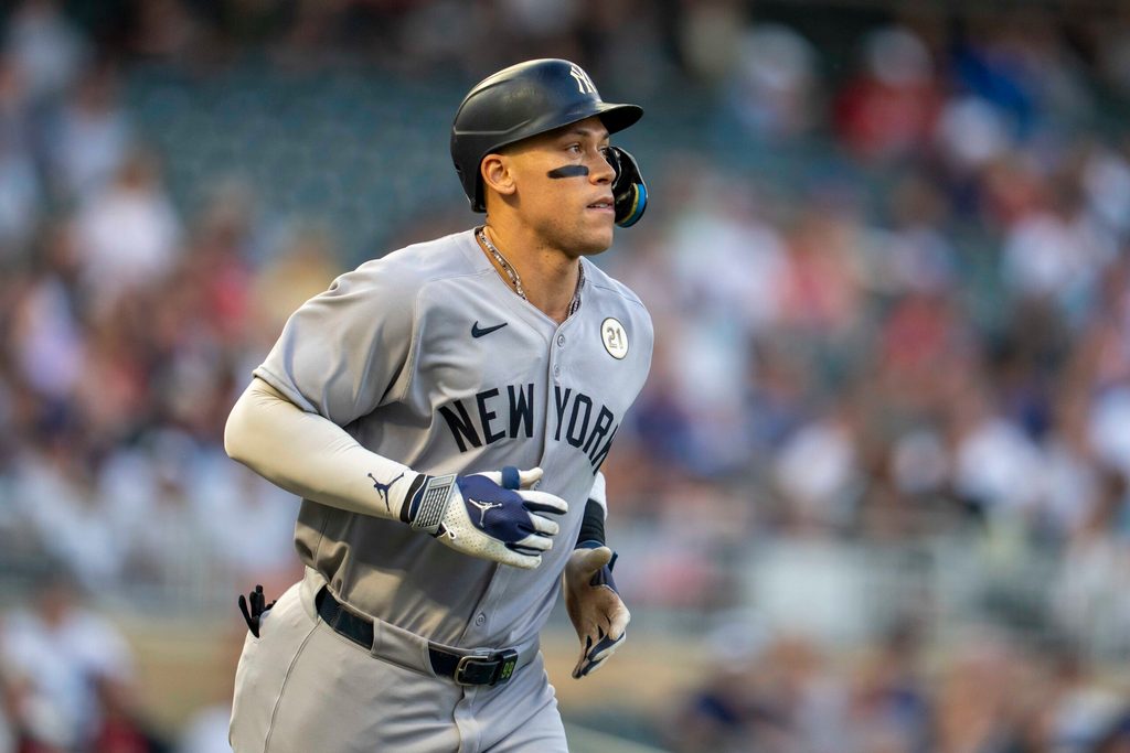 Sep 15, 2025; Minneapolis, Minnesota, USA; New York Yankees right fielder Aaron Judge (99) runs to first base after drawing a walk against the Minnesota Twins in the first inning at Target Field. Mandatory Credit: Jesse Johnson-Imagn Images