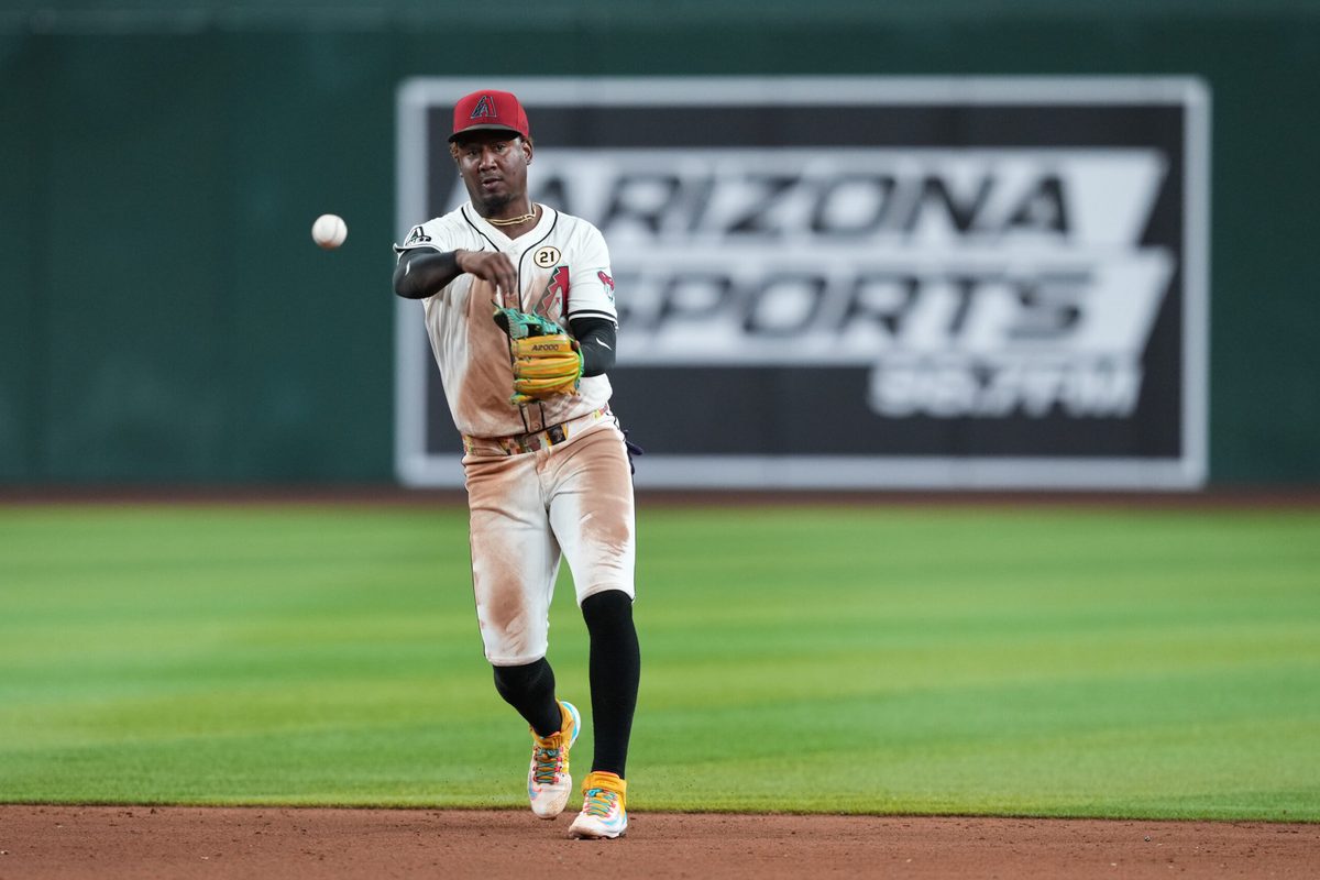 Sep 15, 2025; Phoenix, Arizona, USA; Arizona Diamondbacks shortstop Geraldo Perdomo (2) throws to first against the San Francisco Giants during the ninth inning at Chase Field. Mandatory Credit: Joe Camporeale-Imagn Images