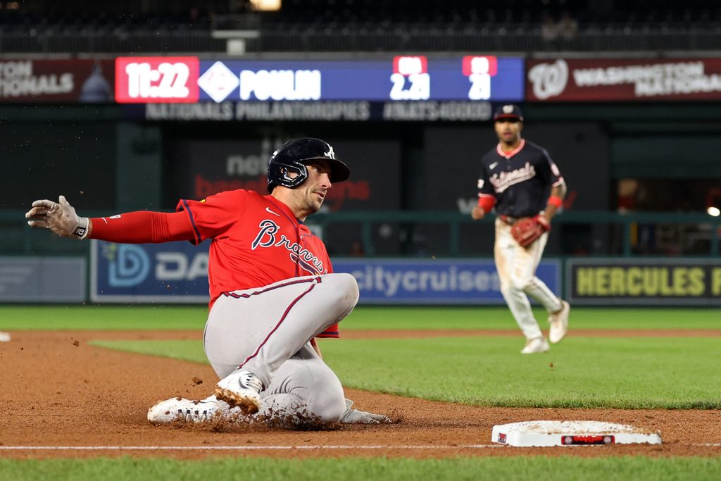 Sep 16, 2025; Washington, District of Columbia, USA; Atlanta Braves first base Matt Olson (28) slides into third base with a three run triple against the Washington Nationals during the tenth inning at Nationals Park. Mandatory Credit: Geoff Burke-Imagn Images