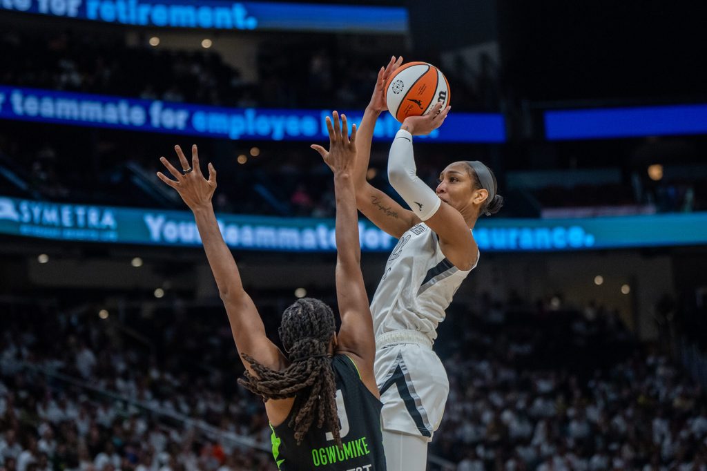 Sep 16, 2025; Seattle, Washington, USA; Las Vegas Aces center A'ja Wilson (22) shoots the ball against Seattle Storm forward Nneka Ogwumike (3) during the second half in game two of round one for the 2025 WNBA Playoffs at Climate Pledge Arena. Mandatory Credit: Stephen Brashear-Imagn Images