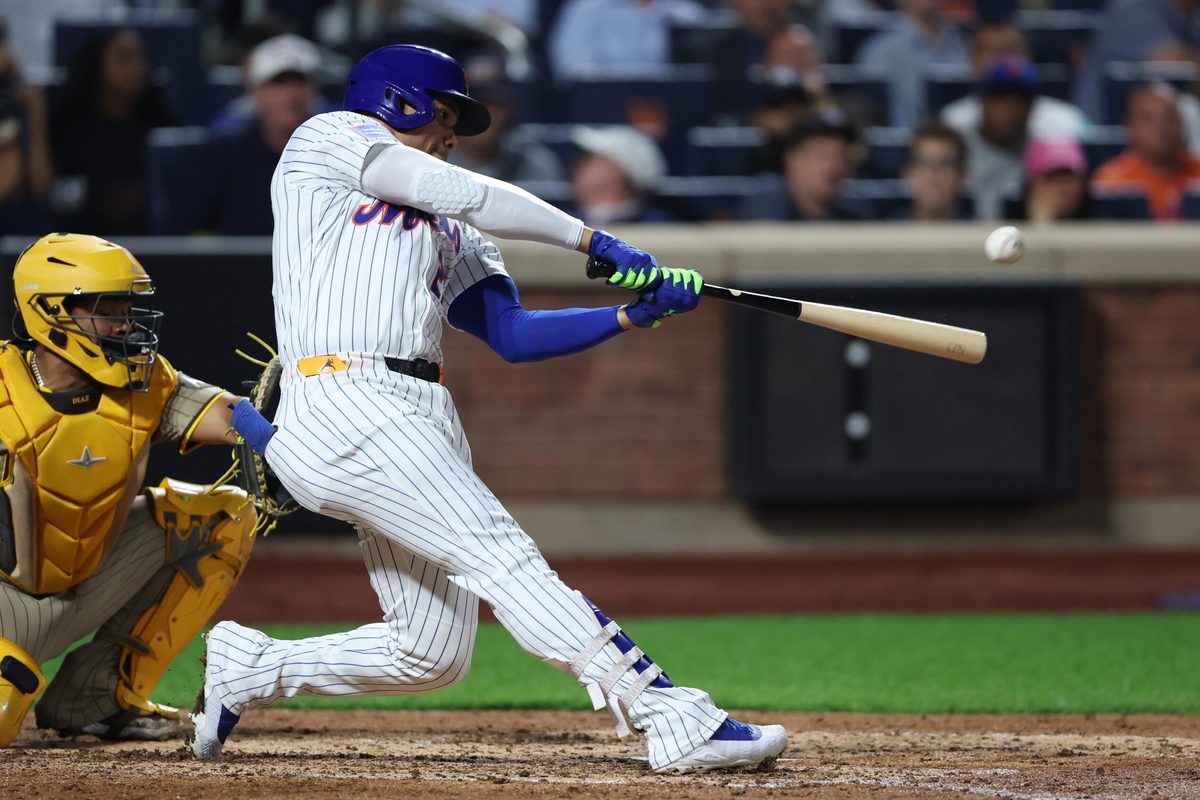 Sep 17, 2025; New York City, New York, USA; New York Mets right fielder Juan Soto (22) hits a home run during the fifth inning against the San Diego Padres at Citi Field. Mandatory Credit: Vincent Carchietta-Imagn Images