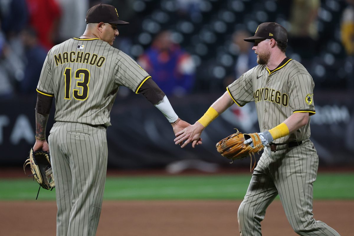 Sep 17, 2025; New York City, New York, USA; San Diego Padres second baseman Jake Cronenworth (9) celebrates with third baseman Manny Machado (13) after the game against the New York Mets at Citi Field. Mandatory Credit: Vincent Carchietta-Imagn Images