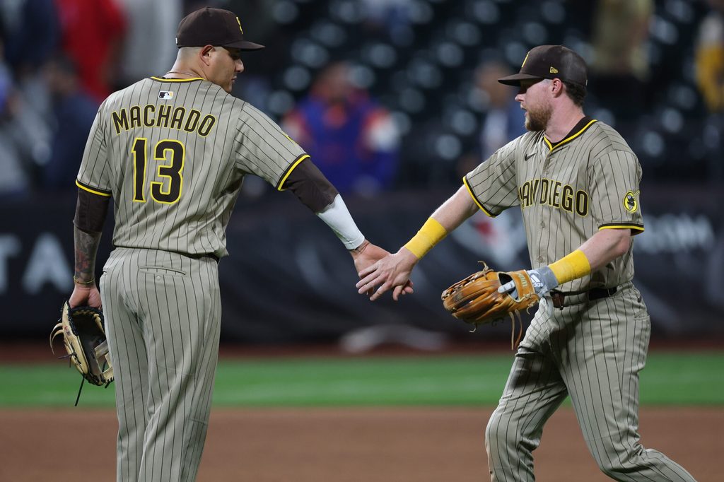 Sep 17, 2025; New York City, New York, USA; San Diego Padres second baseman Jake Cronenworth (9) celebrates with third baseman Manny Machado (13) after the game against the New York Mets at Citi Field. Mandatory Credit: Vincent Carchietta-Imagn Images