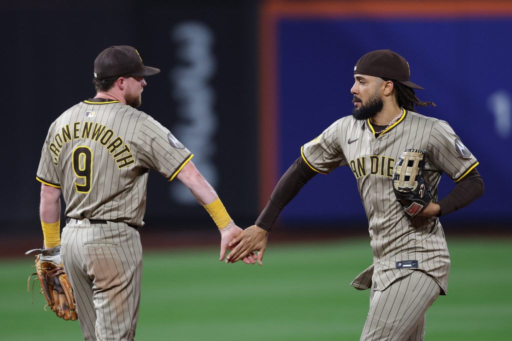 Sep 17, 2025; New York City, New York, USA; San Diego Padres second baseman Jake Cronenworth (9) celebrates with right fielder Fernando Tatis Jr. (23) after the game against the New York Mets at Citi Field. Mandatory Credit: Vincent Carchietta-Imagn Images