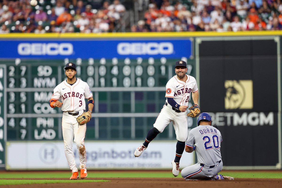Sep 17, 2025; Houston, Texas, USA; Houston Astros second baseman Jose Altuve (27) forces Texas Rangers shortstop Ezequiel Duran (20) out at second base and turns the double play in the eighth inning at Daikin Park. Mandatory Credit: Thomas Shea-Imagn Images