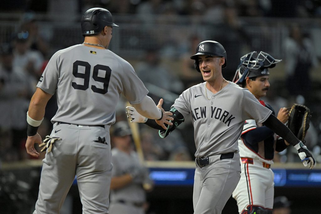 Sep 17, 2025; Minneapolis, Minnesota, USA; New York Yankees designated hitter Aaron Judge (99) congratulates outfielder Cody Bellinger (35) on his two-run home run against the Minnesota Twins during the ninth inning at Target Field. Mandatory Credit: Nick Wosika-Imagn Images