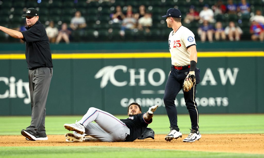 Sep 19, 2025; Arlington, Texas, USA; Miami Marlins center fielder Dane Myers (54) stares at Texas Rangers second baseman Dylan Moore (25) at second base during the twelfth inning at Globe Life Field. Mandatory Credit: Kevin Jairaj-Imagn Images