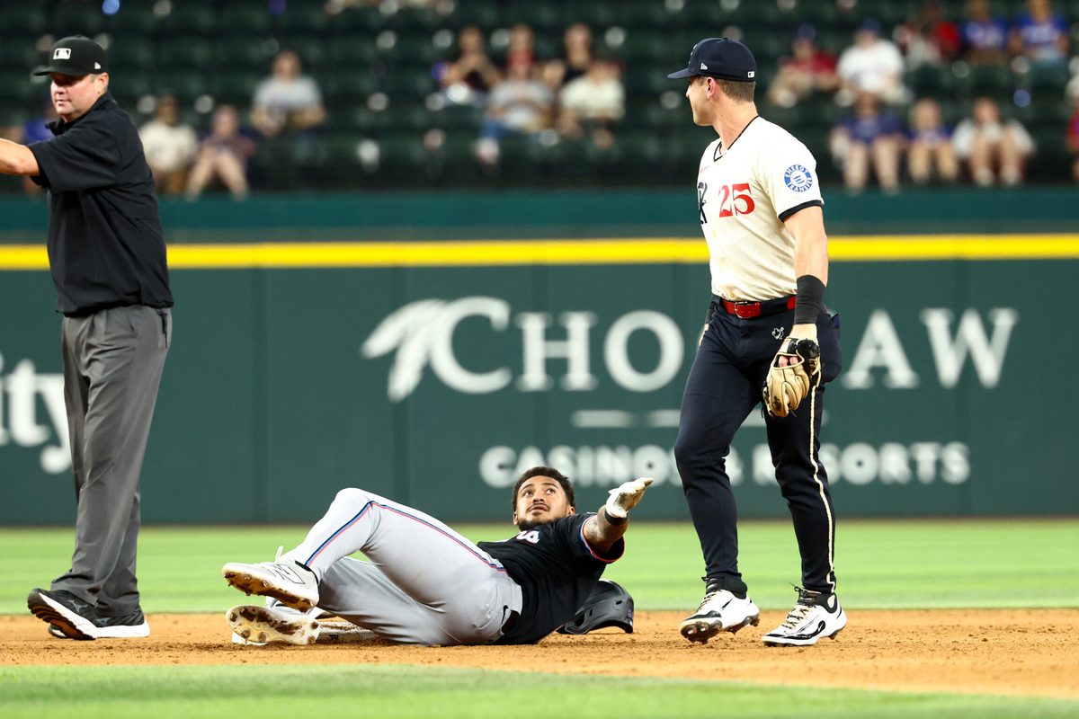 Sep 19, 2025; Arlington, Texas, USA; Miami Marlins center fielder Dane Myers (54) stares at Texas Rangers second baseman Dylan Moore (25) at second base during the twelfth inning at Globe Life Field. Mandatory Credit: Kevin Jairaj-Imagn Images