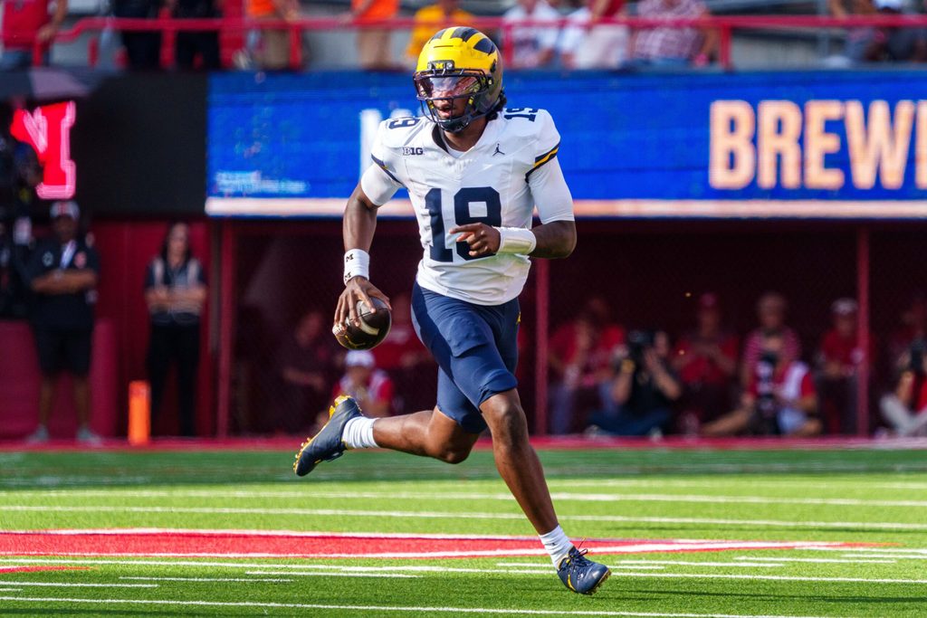 Sep 20, 2025; Lincoln, Nebraska, USA; Michigan Wolverines quarterback Bryce Underwood (19) scrambles against the Nebraska Cornhuskers during the third quarter at Memorial Stadium. Mandatory Credit: Dylan Widger-Imagn Images