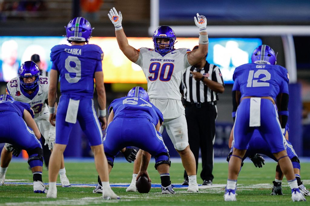 Sep 20, 2025; Colorado Springs, Colorado, USA; Boise State Broncos defensive lineman Braxton Fely (90) motions at the line of scrimmage against Air Force Falcons guard Costen Cooley (67) and quarterback Liam Szarka (9) and fullback Terrence Gist (12) in the fourth quarter at Falcon Stadium. Mandatory Credit: Isaiah J. Downing-Imagn Images