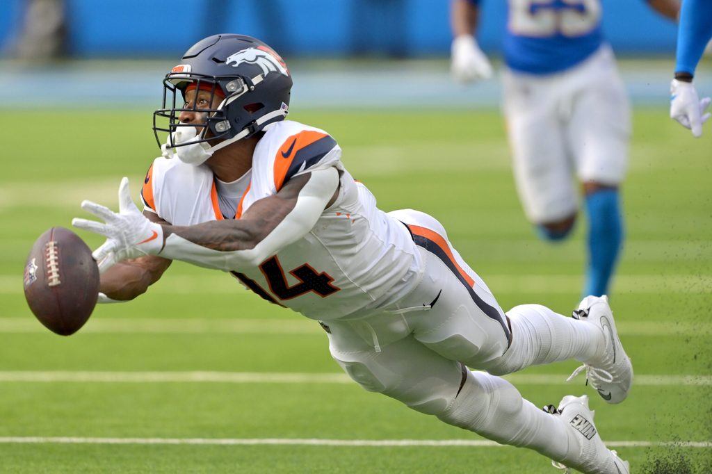 Sep 21, 2025; Inglewood, California, USA; Denver Broncos wide receiver Courtland Sutton (14) reaches for a long pass 4th down in the second half against the Los Angeles Chargers at SoFi Stadium. Mandatory Credit: Jayne Kamin-Oncea-Imagn Images