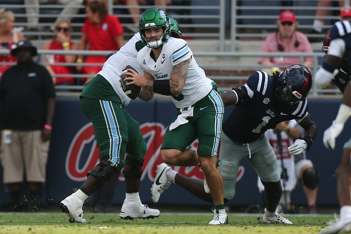 Sep 20, 2025; Oxford, Mississippi, USA; Tulane Green Wave quarterback Brendan Sullivan (6) runs the ball as Mississippi Rebels linebacker Princewill Umanmielen (1) attempts to make the tackle during the fourth quarter at Vaught-Hemingway Stadium. Mandatory Credit: Petre Thomas-Imagn Images