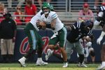 Sep 20, 2025; Oxford, Mississippi, USA; Tulane Green Wave quarterback Brendan Sullivan (6) runs the ball as Mississippi Rebels linebacker Princewill Umanmielen (1) attempts to make the tackle during the fourth quarter at Vaught-Hemingway Stadium. Mandatory Credit: Petre Thomas-Imagn Images