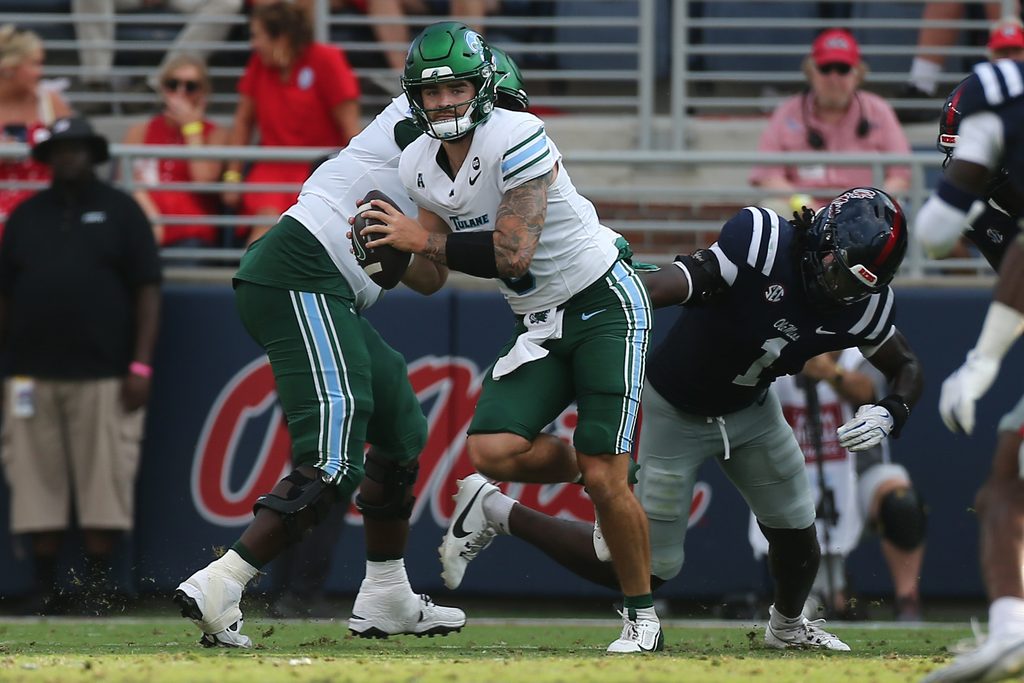 Sep 20, 2025; Oxford, Mississippi, USA; Tulane Green Wave quarterback Brendan Sullivan (6) runs the ball as Mississippi Rebels linebacker Princewill Umanmielen (1) attempts to make the tackle during the fourth quarter at Vaught-Hemingway Stadium. Mandatory Credit: Petre Thomas-Imagn Images