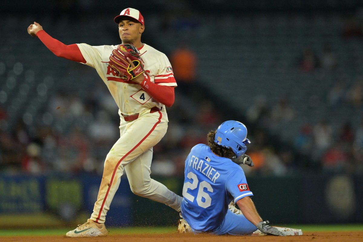 Sep 24, 2025; Anaheim, California, USA; Kansas City Royals second baseman Adam Frazier (26) is out as Los Angeles Angels second baseman Christian Moore (4) throws to first for a double play in the eighth inning at Angel Stadium. Mandatory Credit: Jayne Kamin-Oncea-Imagn Images