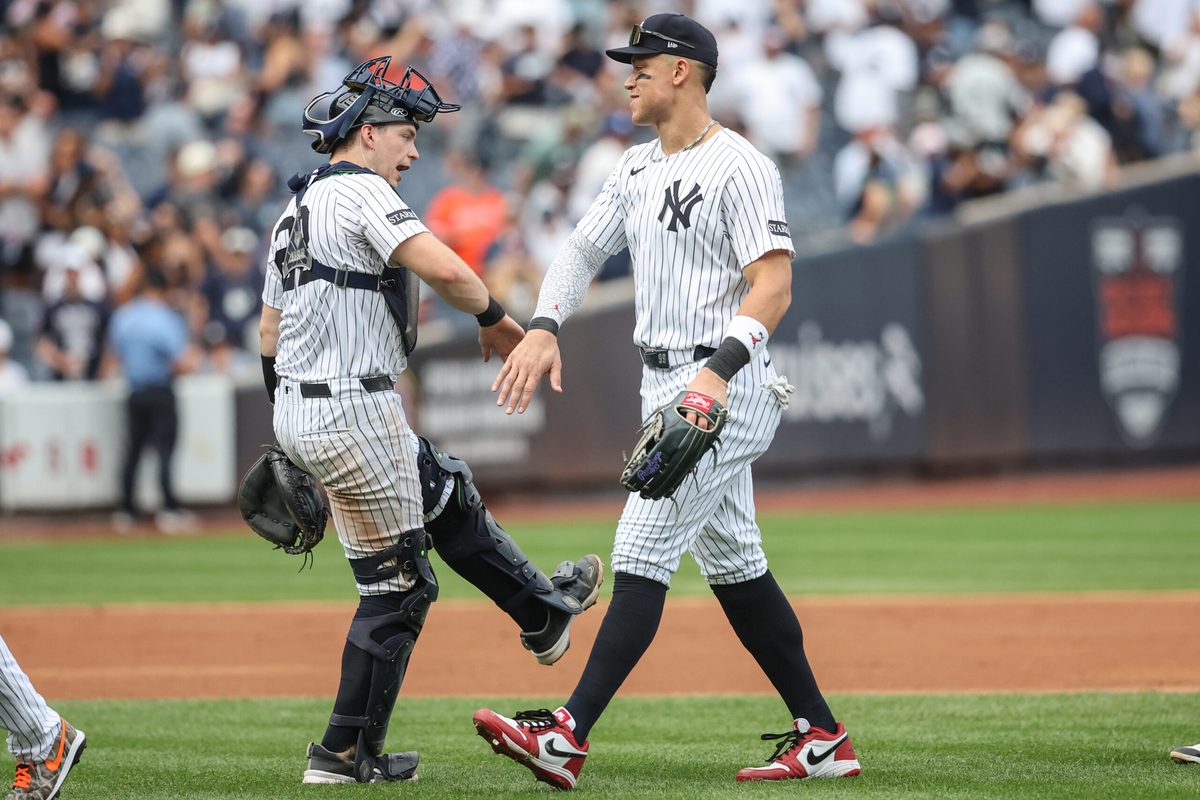 Sep 27, 2025; Bronx, New York, USA; New York Yankees catcher Ben Rice (22) and right fielder Aaron Judge (99) celebrate after defeating the Baltimore Orioles 6-1 at Yankee Stadium. Mandatory Credit: Wendell Cruz-Imagn Images