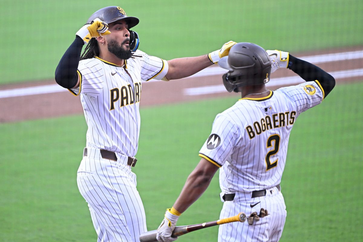 Sep 27, 2025; San Diego, California, USA; San Diego Padres right fielder Fernando Tatis Jr. (23) is congratulated by Luis Arraez (4) after hitting a solo home run during the first inning against the Arizona Diamondbacks at Petco Park. Mandatory Credit: Denis Poroy-Imagn Images