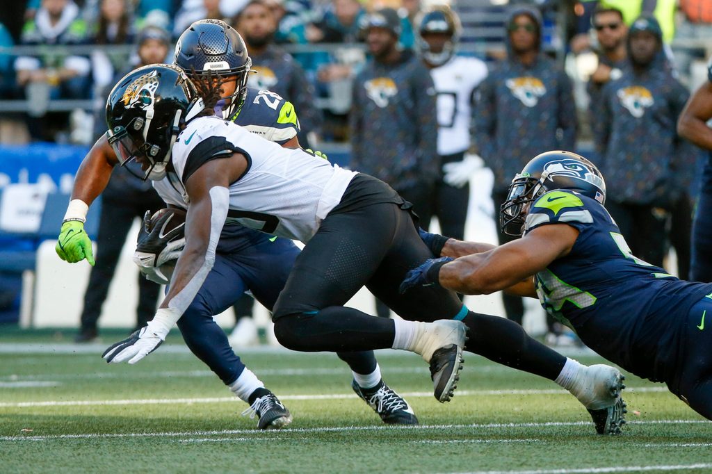 Oct 31, 2021; Seattle, Washington, USA; Jacksonville Jaguars wide receiver Laviska Shenault Jr. (10) runs for yards after the catch as Seattle Seahawks middle linebacker Bobby Wagner (54) reaches for a tackle during the fourth quarter at Lumen Field. Mandatory Credit: Joe Nicholson-Imagn Images