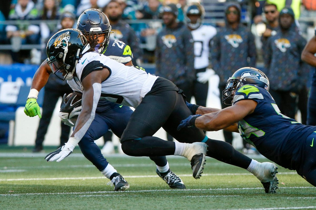 Oct 31, 2021; Seattle, Washington, USA; Jacksonville Jaguars wide receiver Laviska Shenault Jr. (10) runs for yards after the catch as Seattle Seahawks middle linebacker Bobby Wagner (54) reaches for a tackle during the fourth quarter at Lumen Field. Mandatory Credit: Joe Nicholson-Imagn Images