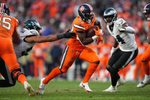 Nov 14, 2021; Denver, Colorado, USA; Denver Broncos running back Javonte Williams (33) carries the ball in the third quarter against the Philadelphia Eagles at Empower Field at Mile High. Mandatory Credit: Ron Chenoy-Imagn Images
