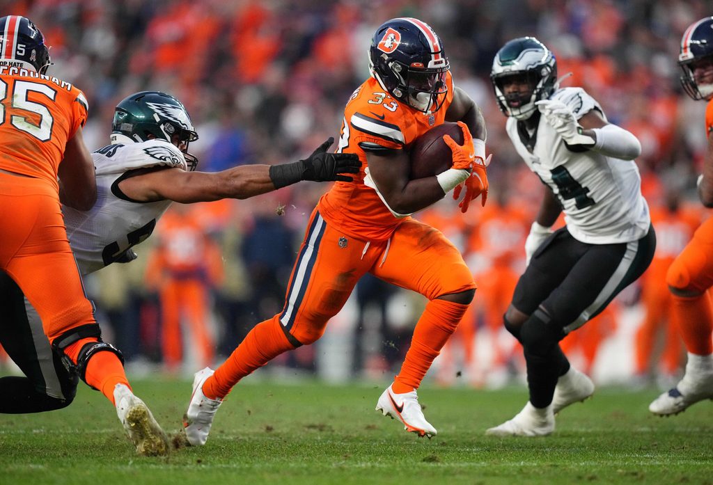 Nov 14, 2021; Denver, Colorado, USA; Denver Broncos running back Javonte Williams (33) carries the ball in the third quarter against the Philadelphia Eagles at Empower Field at Mile High. Mandatory Credit: Ron Chenoy-Imagn Images