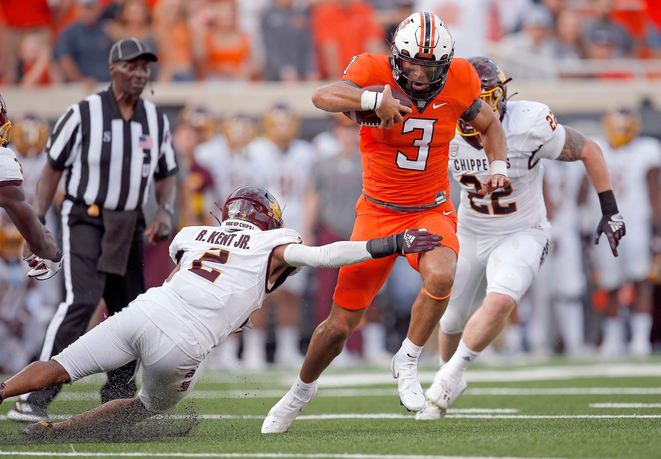Oklahoma State's Spencer Sanders (3) get by Central Michigan's Ronald Kent Jr. (2) on his way to a touchdown in first quarter during the college football game between the Oklahoma State Cowboys and Central Michigan Chippewa at Boone Pickens Stadium in Stillwater, Oka., Thursday, Sept., 1, 2022. OSU won 58-44.

Osu Vs Central Michigan