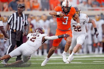 Oklahoma State's Spencer Sanders (3) get by Central Michigan's Ronald Kent Jr. (2) on his way to a touchdown in first quarter during the college football game between the Oklahoma State Cowboys and Central Michigan Chippewa at Boone Pickens Stadium in Stillwater, Oka., Thursday, Sept., 1, 2022. OSU won 58-44.
Osu Vs Central Michigan