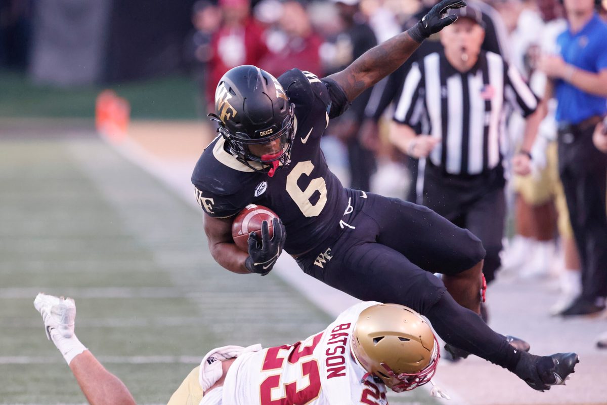 Oct 22, 2022; Winston-Salem, North Carolina, USA; Wake Forest Demon Deacons running back Justice Ellison (6) is brought down by Boston College Eagles defensive back Cole Batson (23) during the second half at Truist Field. Mandatory Credit: Reinhold Matay-Imagn Images