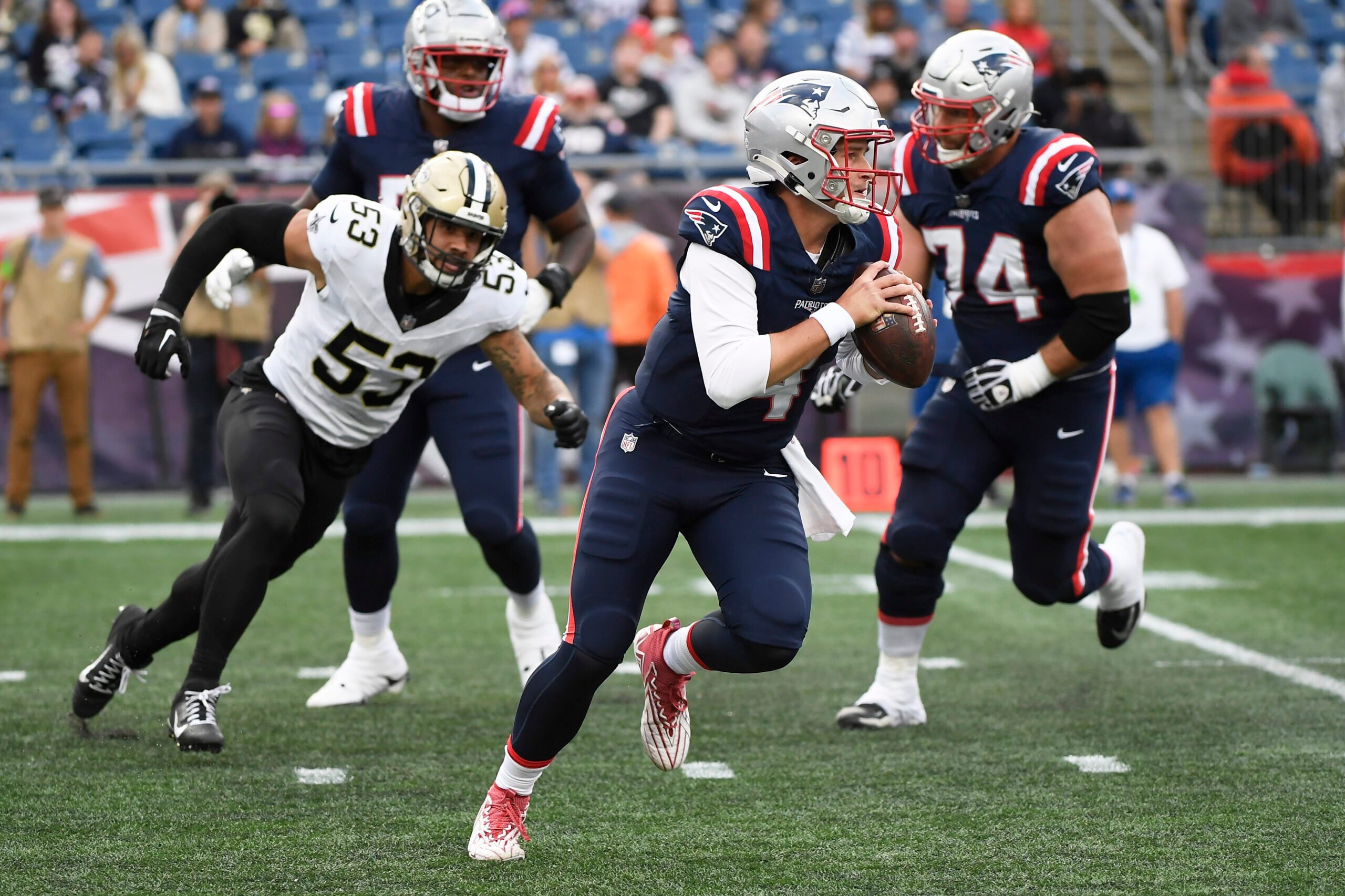 Oct 8, 2023; Foxborough, Massachusetts, USA;  New England Patriots quarterback Bailey Zappe (4) runs with the ball during the second half against the New Orleans Saints at Gillette Stadium. Mandatory Credit: Bob DeChiara-Imagn Images