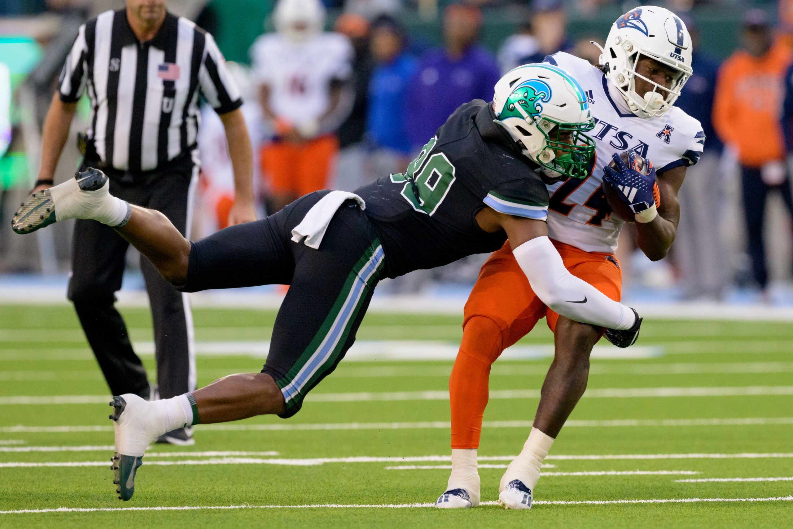 Nov 24, 2023; New Orleans, Louisiana, USA; Tulane Green Wave linebacker Jesus Machado (99) tackles UTSA Roadrunners running back Rocko Griffin (24) during the second half at Yulman Stadium. Mandatory Credit: Matthew Hinton-Imagn Images