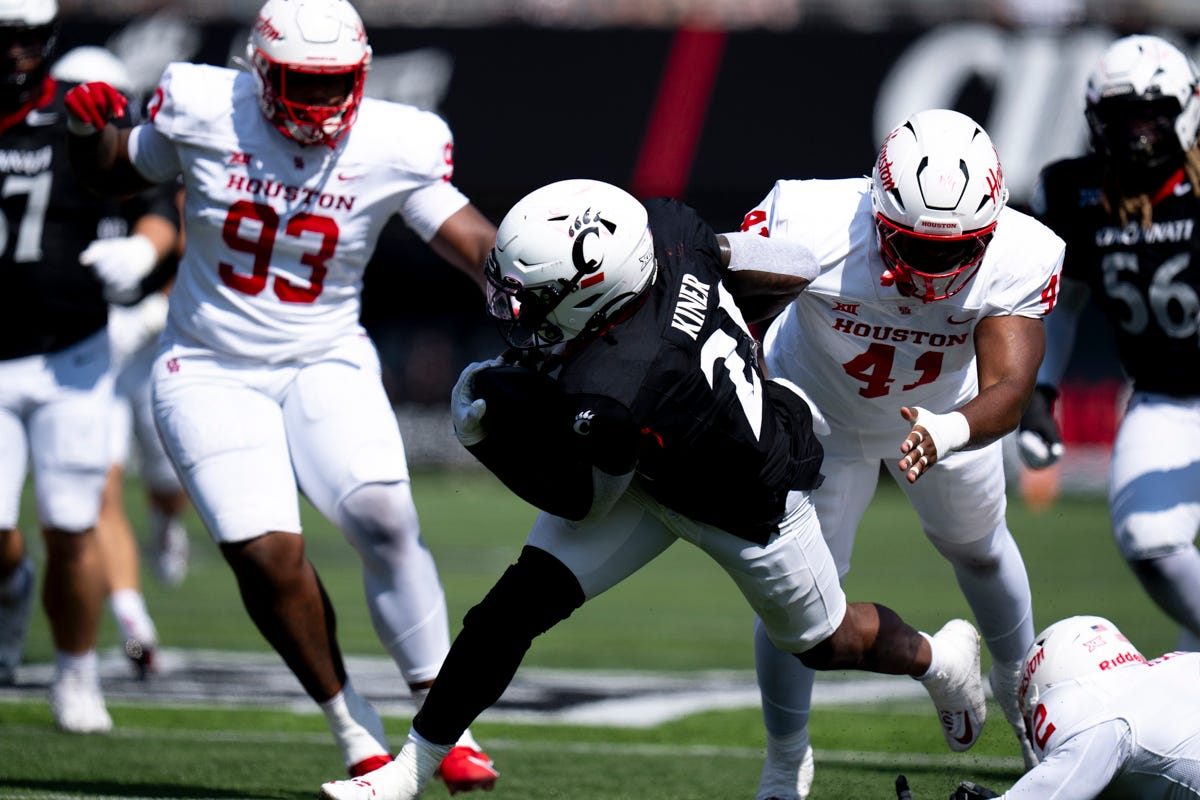 Cincinnati Bearcats running back Corey Kiner (21) breaks a tackle attempt in the second quarter of the College Football game against the Houston Cougars at Nippert Stadium in Cincinnati on Saturday, Sept. 21, 2024.