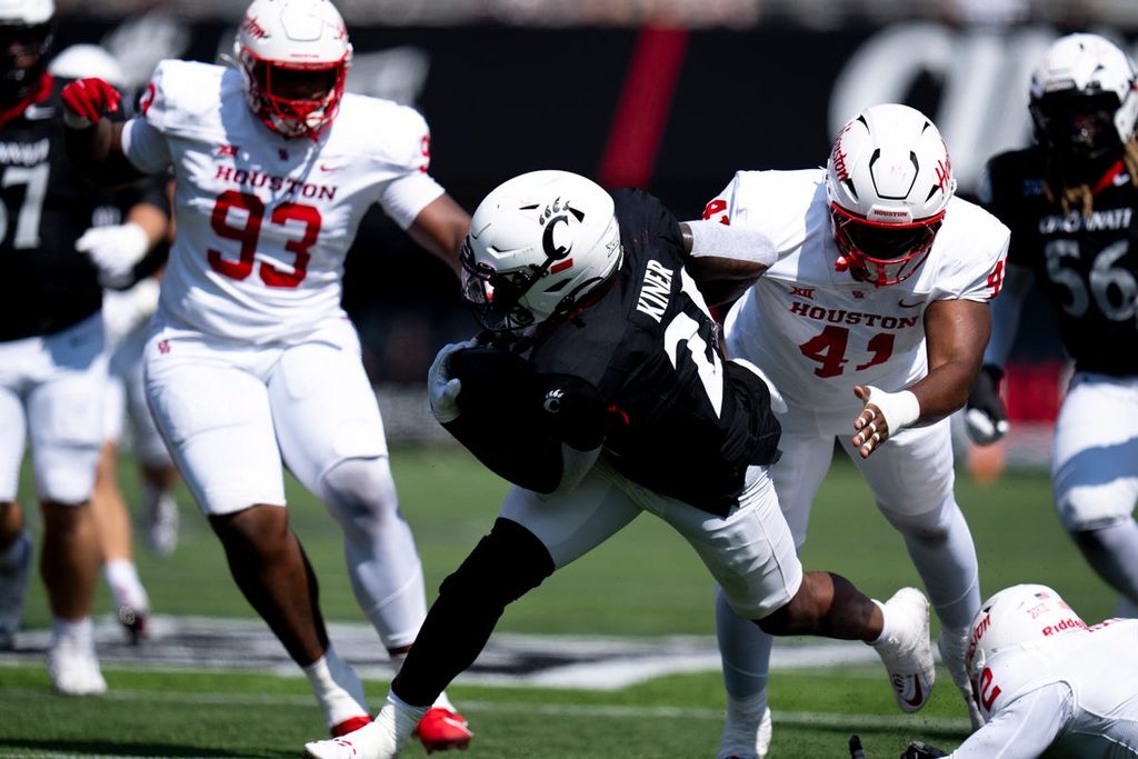 Cincinnati Bearcats running back Corey Kiner (21) breaks a tackle attempt in the second quarter of the College Football game against the Houston Cougars at Nippert Stadium in Cincinnati on Saturday, Sept. 21, 2024.