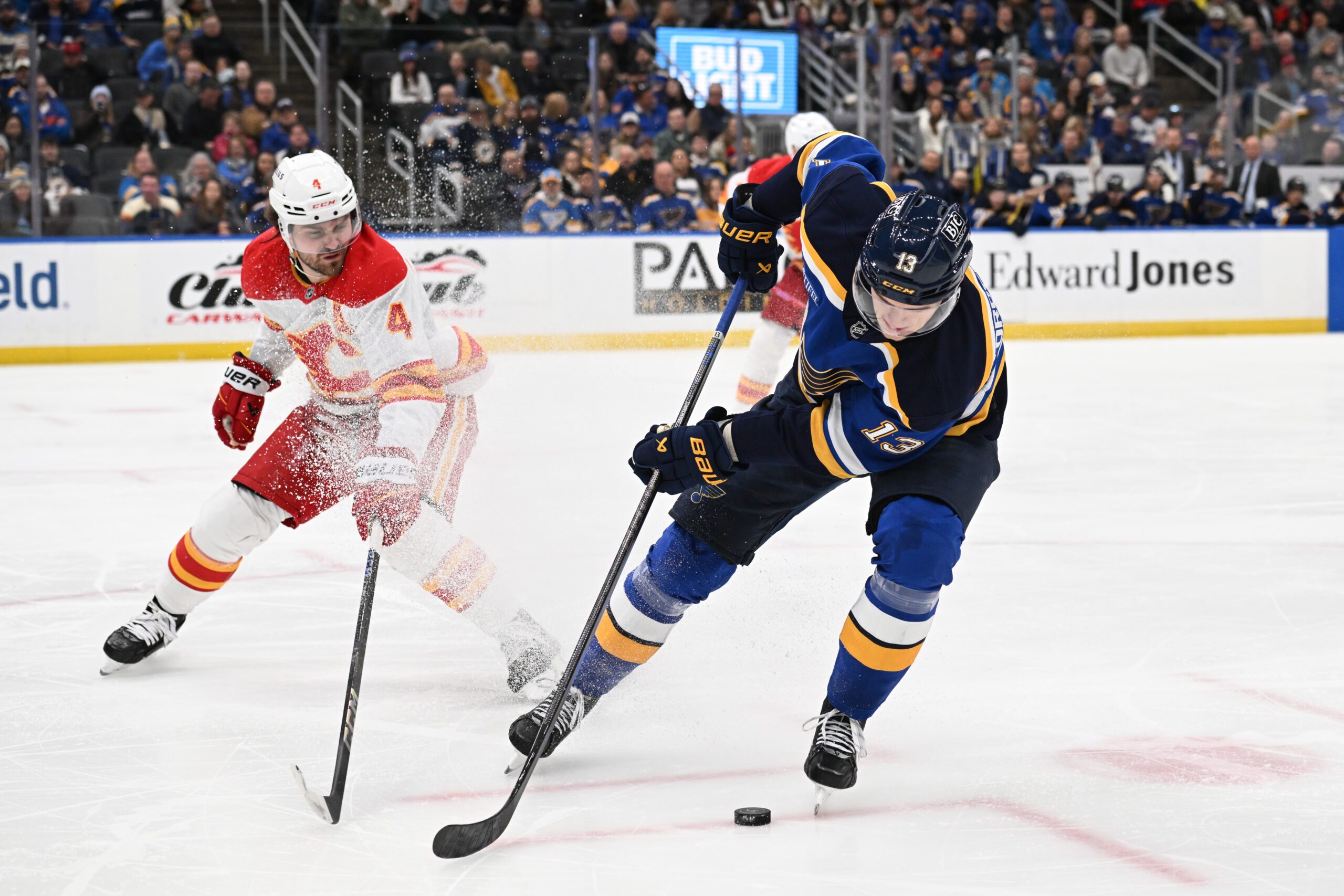 Jan 16, 2025; St. Louis, Missouri, USA; Calgary Flames defenseman Rasmus Andersson (4) defends against St. Louis Blues right wing Alexey Toropchenko (13) in the second period at Enterprise Center. Mandatory Credit: Joe Puetz-Imagn Images
