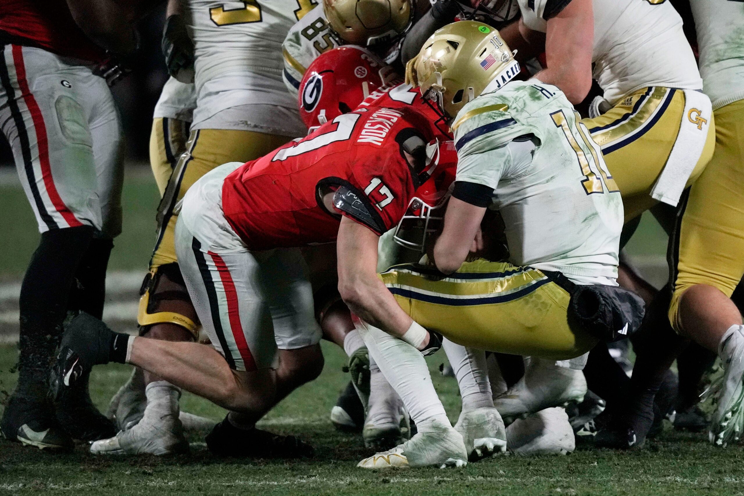 Georgia defensive back Dan Jackson (17) hits the ball forcing a fumble by Georgia Tech quarterback Jeff Sims (10) during the second half of a NCAA college football game against Georgia Tech in Athens, Ga., on Friday, Nov. 29, 2024.
