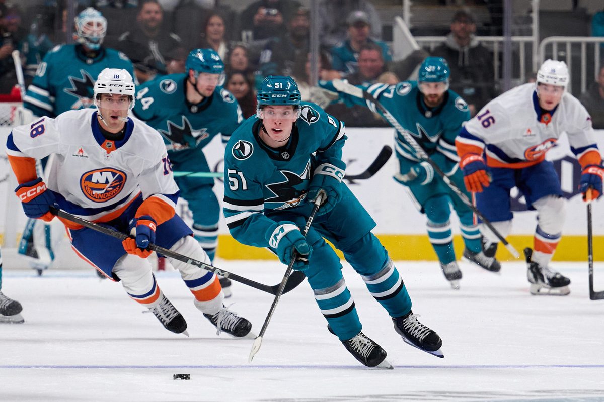 Mar 8, 2025; San Jose, California, USA; San Jose Sharks right wing Collin Graf (51) skates with the puck against New York Islanders left wing Pierre Engvall (18) during the second period at SAP Center at San Jose. Mandatory Credit: Robert Edwards-Imagn Images